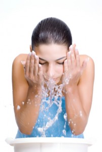 Woman washing face at home